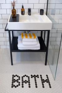 a bathroom sink with towels on a shelf under a sink at Cedori Butik Otel in Ezine +45 photos