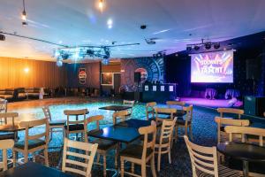 a room with tables and chairs and a stage at Solway Holiday Park in Silloth +58 photos
