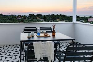 a table and chairs on a balcony with a view at Cedori Butik Otel in Ezine