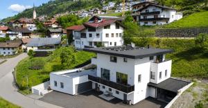 an aerial view of a white house in a village at Apart Kathrin in Fliess
