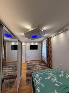 a bedroom with a bed and a blue ceiling at Kaira place in Lupeni +4 photos