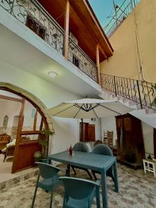 a table and chairs with an umbrella in a room at MAGIC MOON guest house in Famagusta