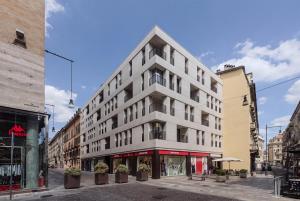 a tall white building on a city street at Dune Luxury Residence in Turin