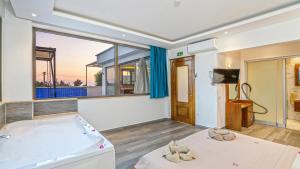 a room with a bed and a large window at Secluded Sea View Honeymoon Escape Jacuzzi Private Pool-Villa Bella1 Orkide in Üzümlü +48 photos