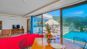 a living room with a red couch and a pool at Secluded Sea View Honeymoon Escape Jacuzzi Private Pool-Villa Bella1 Orkide in Üzümlü