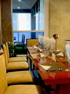 a dining room with a table with wine glasses at Galaxy La Palm Royal Hotel in Port Harcourt