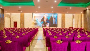 a row of purple chairs in a banquet hall at Galaxy La Palm Royal Hotel in Port Harcourt