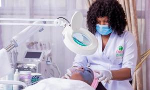a woman in a dental clinic with a patient at Galaxy La Palm Royal Hotel in Port Harcourt