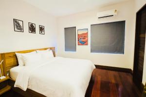 a bedroom with a white bed and a window at Ploythai Villa 2 in Haad Pleayleam +15 photos