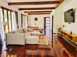 a living room with a couch and a table at Ploythai Villa 2 in Haad Pleayleam