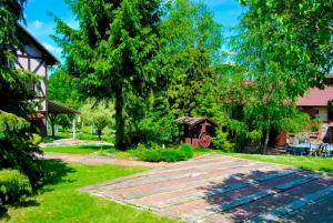 a garden with a pathway and a gazebo at Chata Na Górce in Ostrowice +74 photos