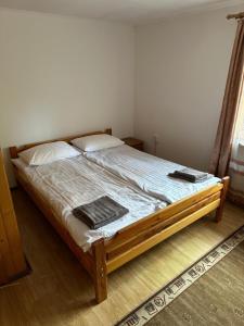 a bed in a bedroom with two pillows on it at Plai in Dragobrat