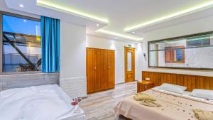 a bedroom with two beds and a large window at Secluded Sea-View Romantic Escape Villa Bella 4 Leylak in Üzümlü +42 photos