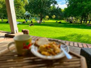 a plate of food on a table with a cup of coffee at Chata Na Górce in Ostrowice