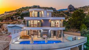 a large house with a swimming pool in front of it at Luxury Valley-View Escape in Islamlar -Villa 5 Kartal Yuvası in Üzümlü