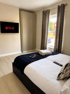 a large bed in a room with a window at Wellingborough Luxury Staycation 3 Bed 2 Bath in Wellingborough