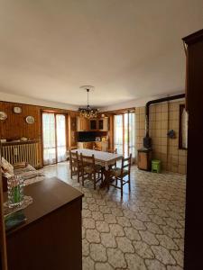 a kitchen and dining room with a table and chairs at Mizoun Paola Via Roma 9 in Aisone