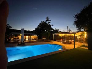 a swimming pool in front of a house at night at La minada in Covelo