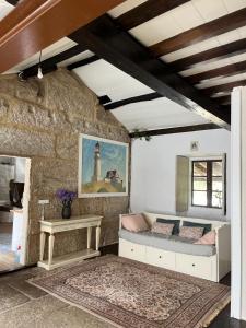 a room with a couch and a table and a lighthouse at La minada in Covelo