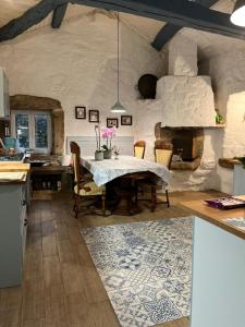a kitchen with a table and a stone fireplace at La minada in Covelo