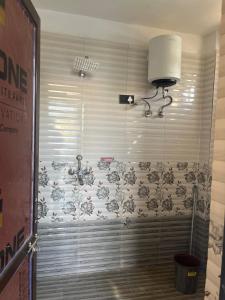 a bathroom with a shower with a wall at lavender hill in Jaipur