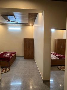 a room with two beds and a wall with two mirrors at lavender hill in Jaipur