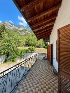 a balcony with a view of a mountain at Mizoun Paola Via Roma 9 in Aisone