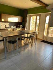 a kitchen with a large wooden table and chairs at Eden in Ceton