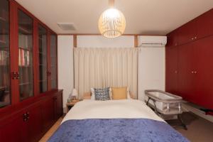 a bedroom with a bed and a desk and a chandelier at Cove琴平 - 1組貸切 最大8名 こんぴらさん徒歩すぐ in Kotohira +63 photos