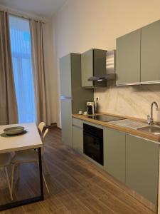 a kitchen with stainless steel appliances and a table at Majella vista Mare in Guardiagrele