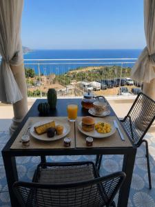 a breakfast table with breakfast foods on a balcony at Amaurusa Boutique Hotel in Taormina +26 photos