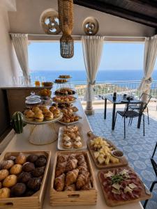 a table with many different types of pastries at Amaurusa Boutique Hotel in Taormina
