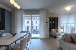 a living room with a couch and a table and chairs at Dune Luxury Residence in Turin