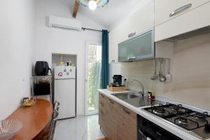 a kitchen with a sink and a refrigerator at Casa Rosetta - vicino Bordighera in Vallebona