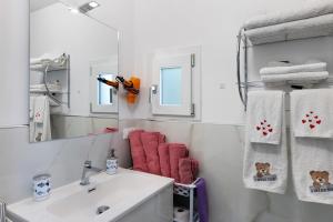 a bathroom with a sink and a mirror and towels at Casa Rosetta - vicino Bordighera in Vallebona +11 photos