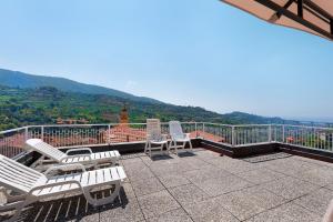 a balcony with chairs and a view of a mountain at Casa Rosetta - vicino Bordighera in Vallebona