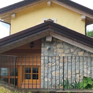 a house with a fence in front of it at Agritur Maso Carpenè in Rovereto