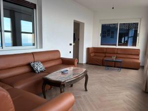 a living room with a couch and a table at La Vista Azul in Belyounech 