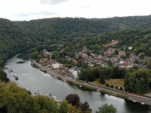 an aerial view of a river with a town at La petite maison 34 in Waulsort
