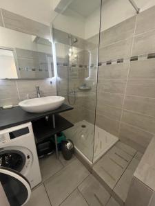 a bathroom with a shower and a sink and a washing machine at Mon Paradis en Provence B29 in Gréoux-les-Bains +5 photos