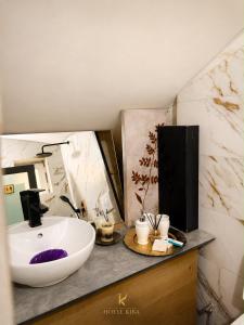 a bathroom with a white sink and a mirror at Hotel Kika in Prishtinë