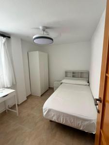a small room with a bed and a table at Bacarola in Los Mártires