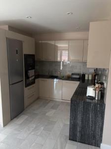 a kitchen with white cabinets and a counter top at W Dolinie in Małkowice