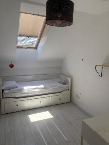 a small bed in a room with a window at W Dolinie in Małkowice +4 photos