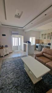 a living room with a couch and a coffee table at Kotor Bay View Apartments in Bijela