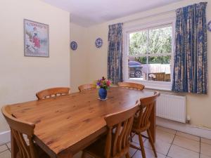 a dining room with a wooden table and chairs at The Lock House in Gloucester