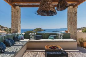 a patio with a couch and a view of the ocean at Apaggio Luxury Villa - Private Pool & Stunning Sea Views, by ZanteWize in Agios Nikolaos +53 photos