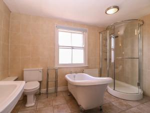 a bathroom with a tub and a toilet and a sink at The Lock House in Gloucester +38 photos