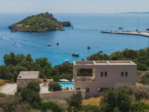 a house with a view of a body of water at Apaggio Luxury Villa - Private Pool & Stunning Sea Views, by ZanteWize in Agios Nikolaos