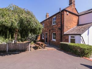 a house with a picnic bench in front of it at The Lock House in Gloucester